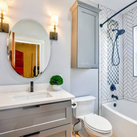 Bathroom Remodeling (3) A white toilet and sink in a bathroom.